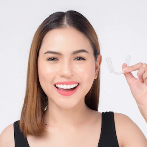 young-smiling-woman-holding-invisalign-braces-studio-dental-healthcare-orthodontic-concept_33799-122